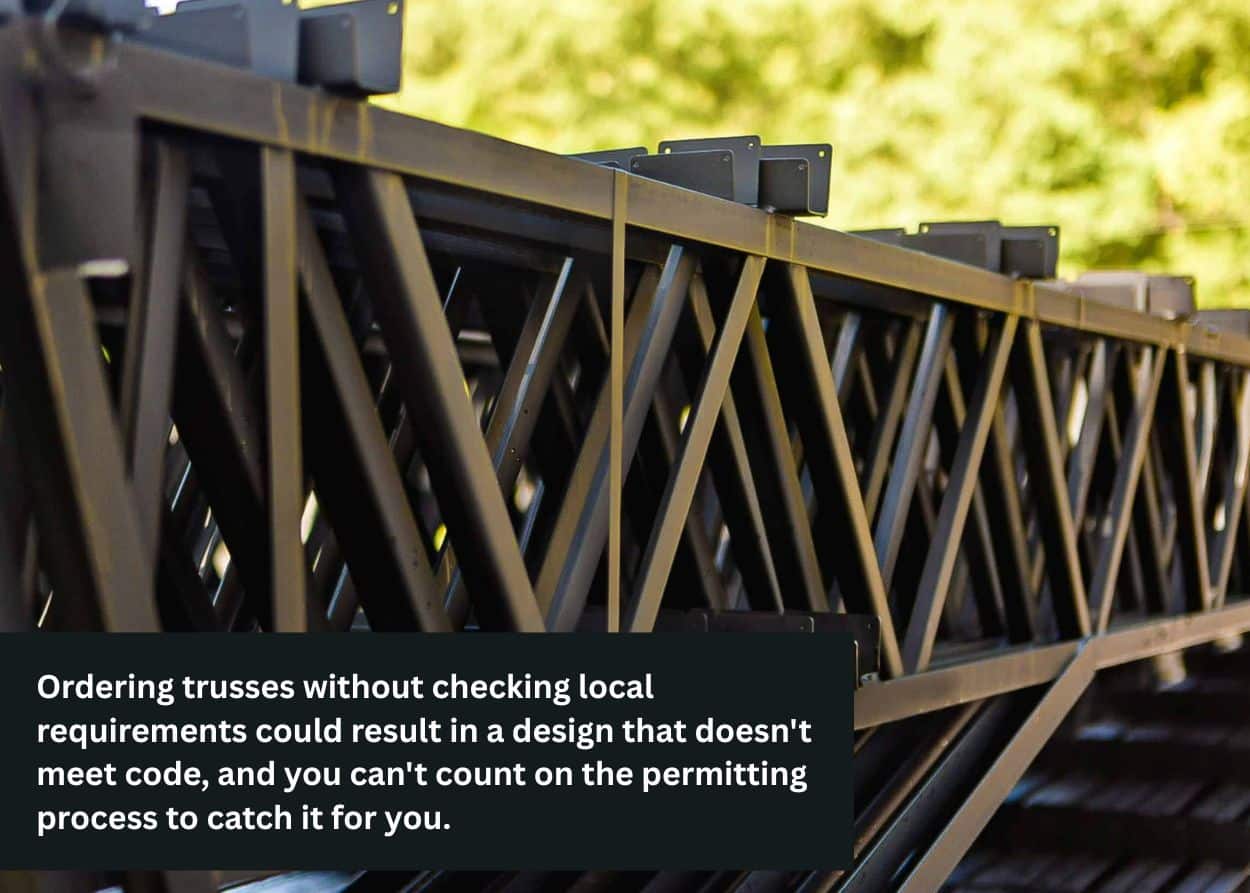 Stack of custom steel roof trusses awaiting delivery, highlighting the importance of accurate truss specifications before fabrication.